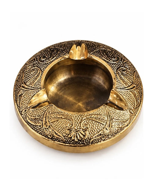 Mehfil round brass ashtray with an embossed paisley and floral rim, on a white background